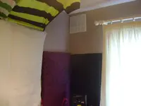 Corner behind left speaker.webp